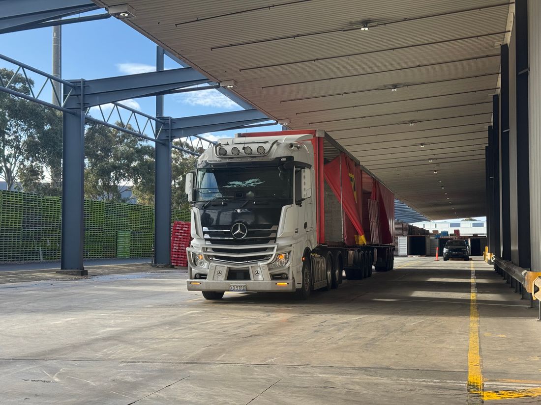 A delivery truck loading at the warehouse dock